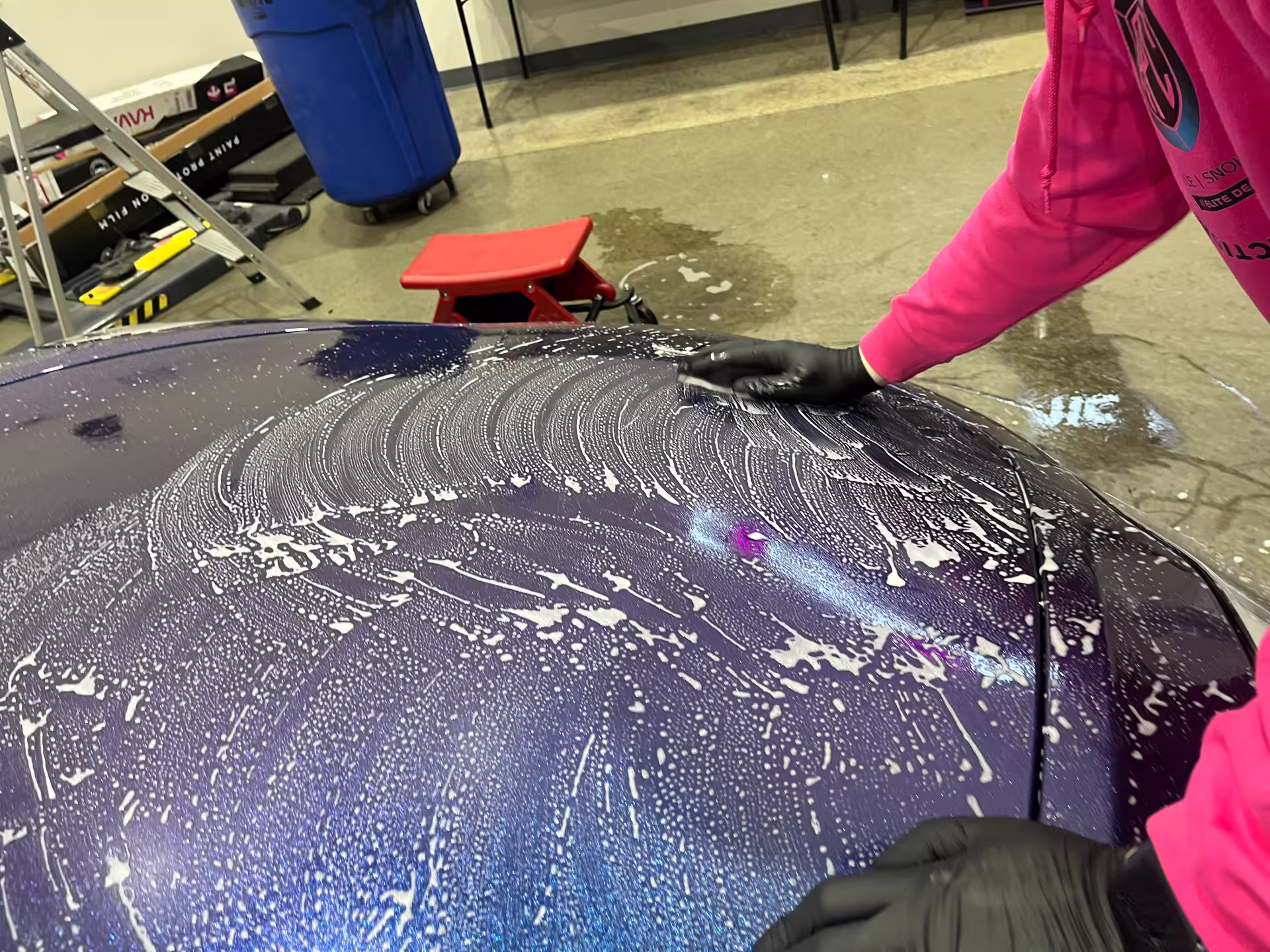 APC Auto Spa technician performing paint decontamination on a new vehicle before ceramic coating
